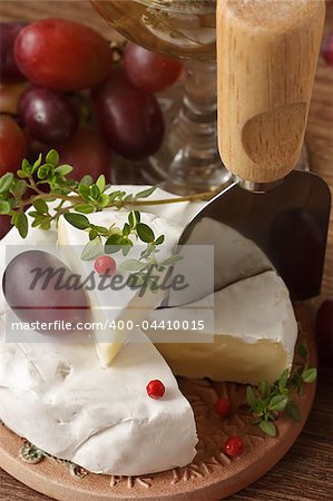 Tasty camembert with red grape and thyme.