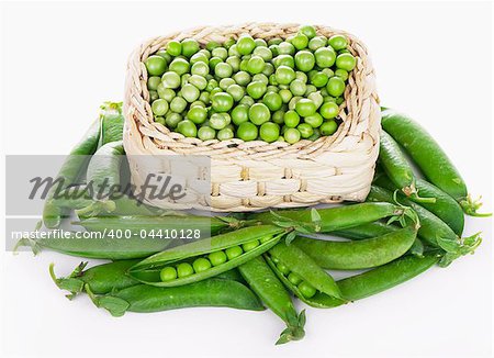 wood basket with green peas the isolated