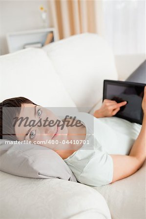 Portrait of a woman using a tablet computer in her living room