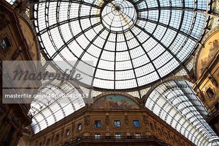 The Galleria Vittorio Emanuele II is a covered double arcade formed of two glass-vaulted arcades at right angles intersecting in an octagon, prominently sited on the northern side of the Piazza del Duomo in Milan.