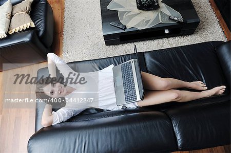 happy young girl working on laplivingroom indoor