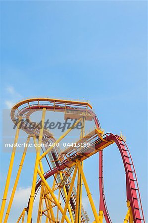 Roller coaster in amusement park under blue sky