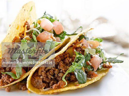 Beef tacos with lettuce cheese and tomato