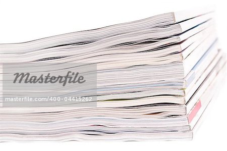 Closeup of a pile of magazines on white background