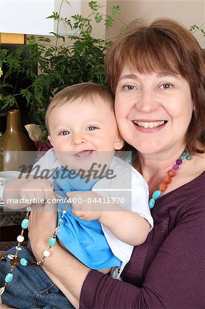 Beautiful baby boy sitting by his grandmother