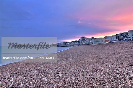 Beautiful sunset over the sea and pier seen from the beach at Worthing, West Sussex - England