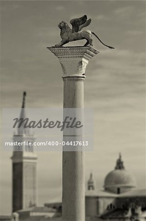 Column with lion - symbol of Venice in front of San Giorgio Maggiore church in Venice, Italy.