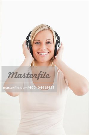 Portrait of a lovely woman enjoying some music against a white background