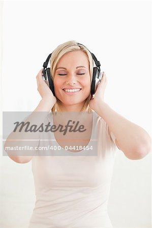 Portrait of a lovely woman listening to music against a white background
