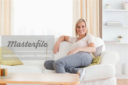 Relaxed woman sitting on a sofa in her living room