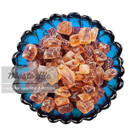 Pieces of caramelized sugar in a bowl on a white background