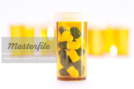 Pill Containers with Green and White capsules inside, all on a bright white background