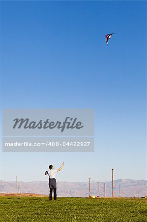 young man flying a kite in the park