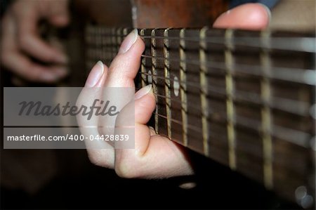 Female hands are palayng a classical guitar