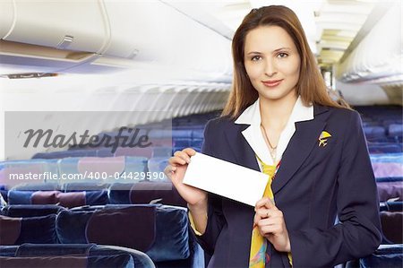 air hostess (stewardess) in the empty airliner cabin