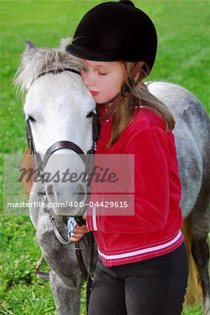 Young girl with a white pony at countryside