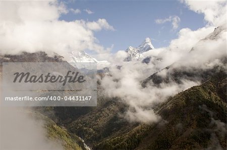 The trail from Namche Bazar to Phunki Tenga, Nepal. You can see Ama Dablam to the right and in the middle Nuptse, Lhotse, and Everest emerge from the clouds.