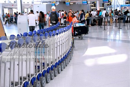 Passengers lining up at the check-in counter at the modern international airport