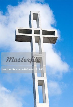 Religious cross against sky background