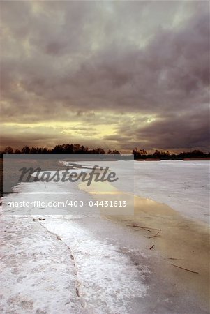 Sunset by a frozen lake