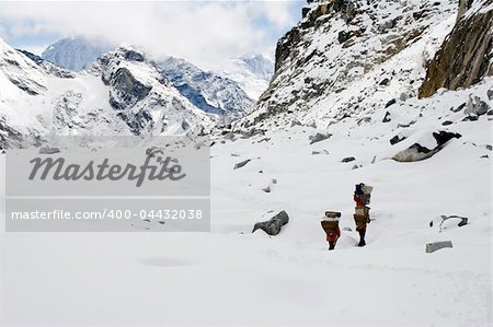 Three porters crossing Cho La Pass from Dragnag to Dzonglha.
