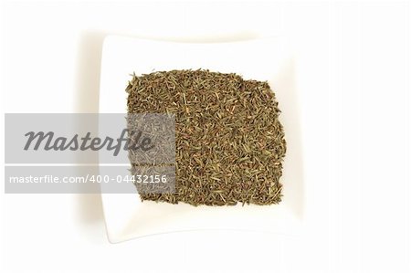 dried thyme in square white bowl isolated