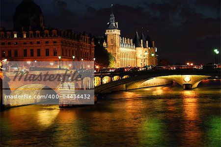 Bridges over Seine and Conciege in nighttime Paris France