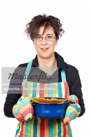 Housewife in apron holding a blue pan with spaghetti uncooked inside