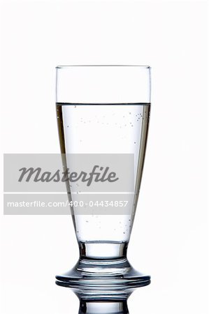 Glass of fresh water reflected on white background