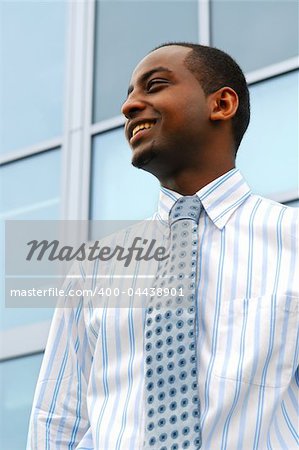 Portrait of a young attractive businessman next to a corporate building