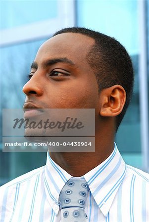 Portrait of a young attractive businessman next to a corporate building