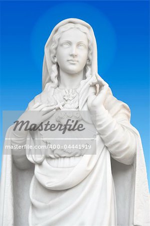 beatiful white statue of Virgin Mary on blue background