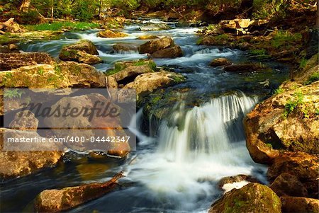 Beautiful landscape of a river cascading over rocks in wilderness