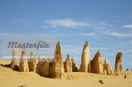 Rock and sand formations next to the sea and desert