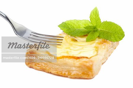 Fork and apple tart with leaves of mint on a dish. Soft shadow, isolated on white background. Shallow DOF