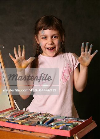 The good little girl. Hands and the face are soiled in a paint