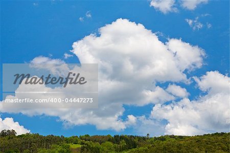 Mountain landscape, green filed, the blue sky and white clouds Mountain landscape, green filed, the blue sky and white clouds
