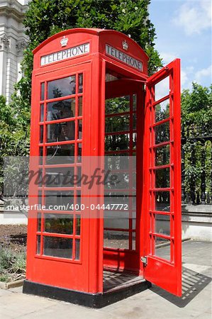 red telephone box with the door open along cannon street london