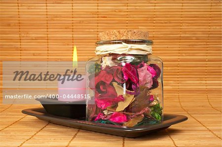 The candle and essence jar on bamboo mat