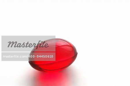 Close up of a vitamins E, a red capsule