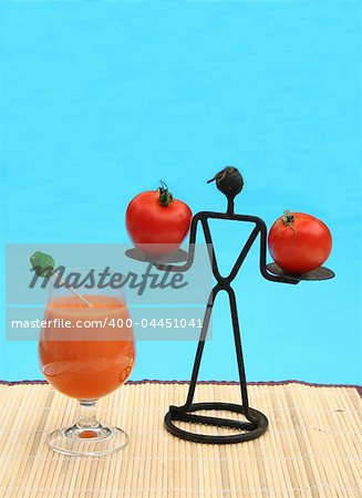 Refreshing vitamin drink and figure with tomatoes