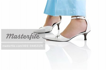 Woman legs with beautiful white shoes on a white background with reflection