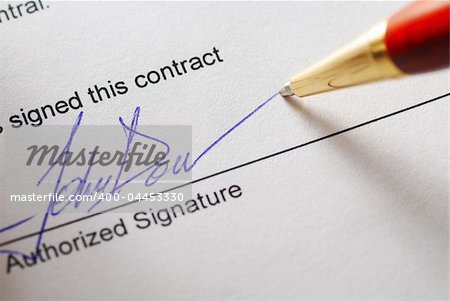 Signing a contract. Shallow depth of field.