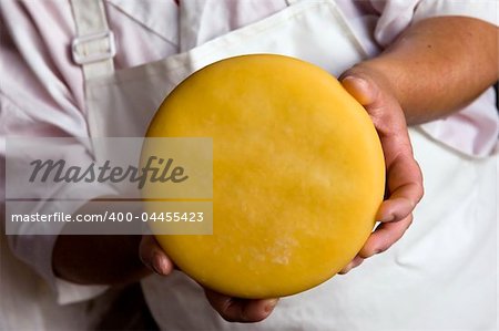 Woman showing cheese in a dairy, Pico Island, Azores, Portugal