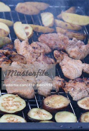 Delicious barbecue grilled meat, potatoes and eggplants
