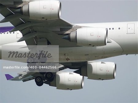 Detail of large, long distance airplane on final approach with landing gear extended.