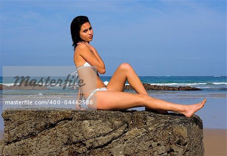 Girl in bikini on a rock