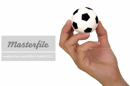 Feminine hand holding miniaturized rubber soccer ball over white background