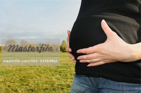 Stomach of pregnant woman with her hands