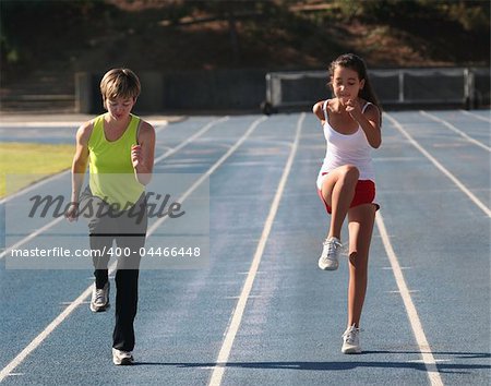 Mother and daughter exercising on a blue racetrack